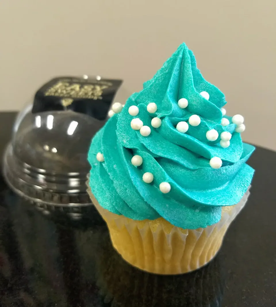 Teal frosted cupcake with pearl sprinkles