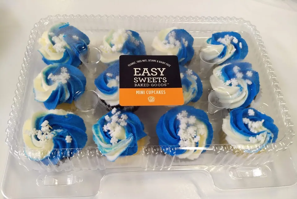 Blue swirl vanilla cupcakes with white sprinkles in an Easy Sweets package